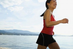 Woman jogging by lake