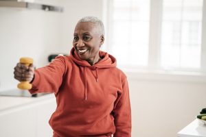 Senior women taking care of herself  she exercise with  dumbbells at home